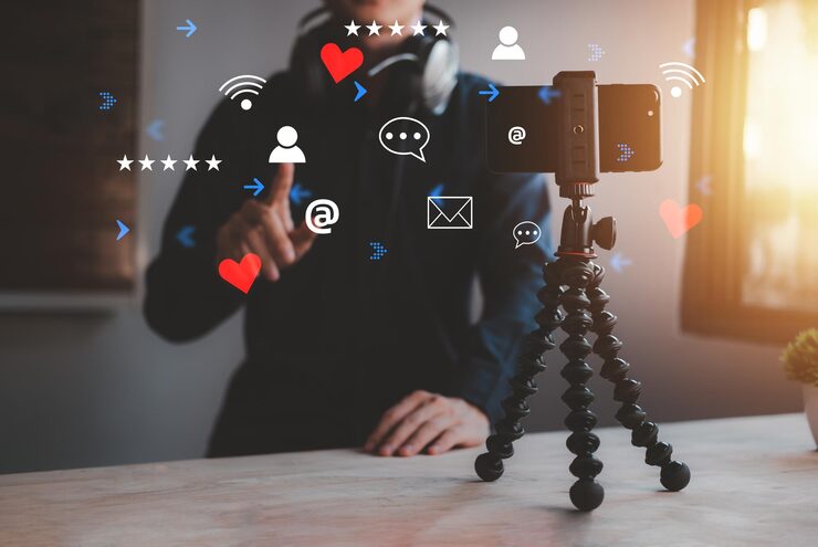 man is streaming live content online with smartphone home room streamer with headphone talk with listening audience new concept vlog 51464 1001